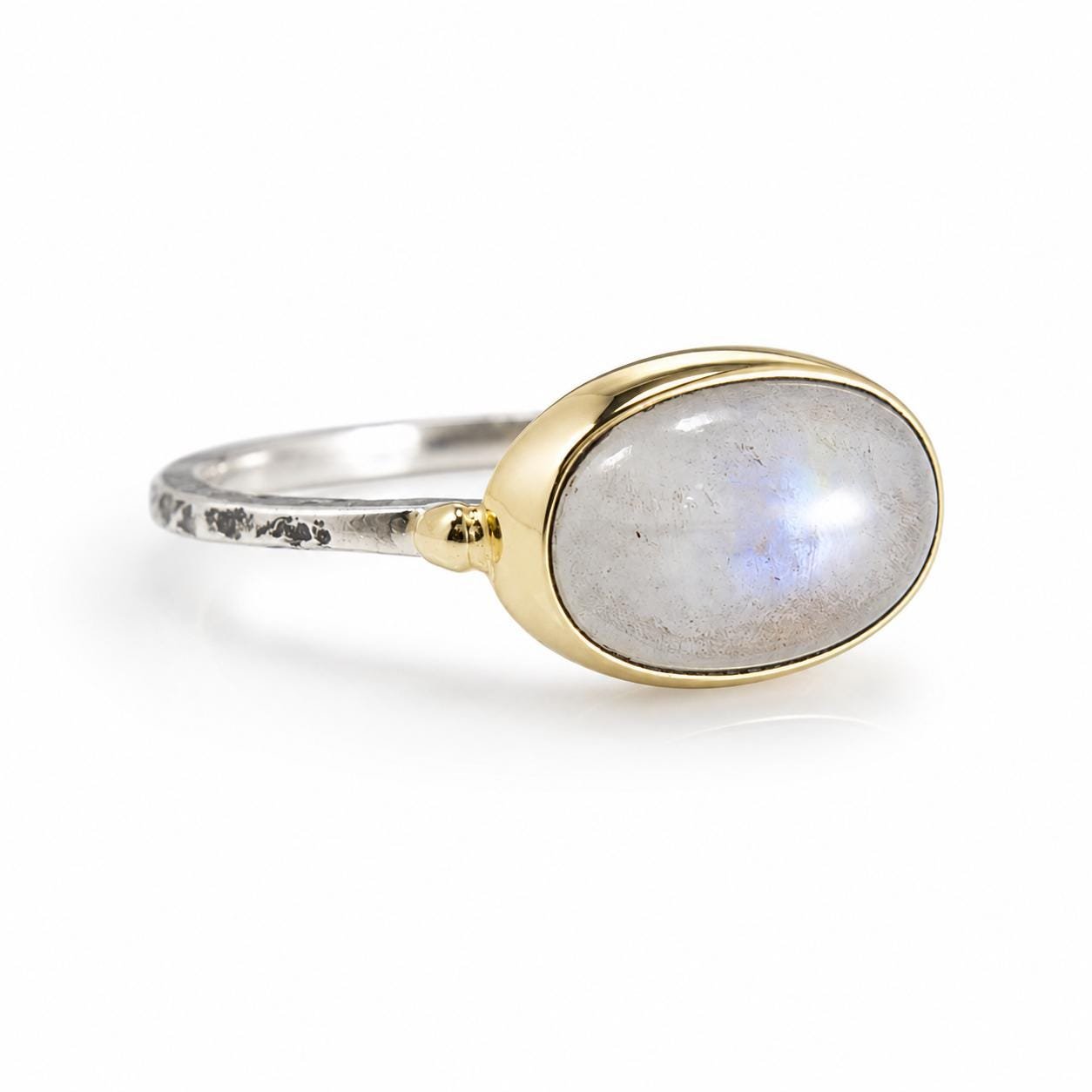 Moonstone ring with oval gemstone and gold bezel in sterling silver